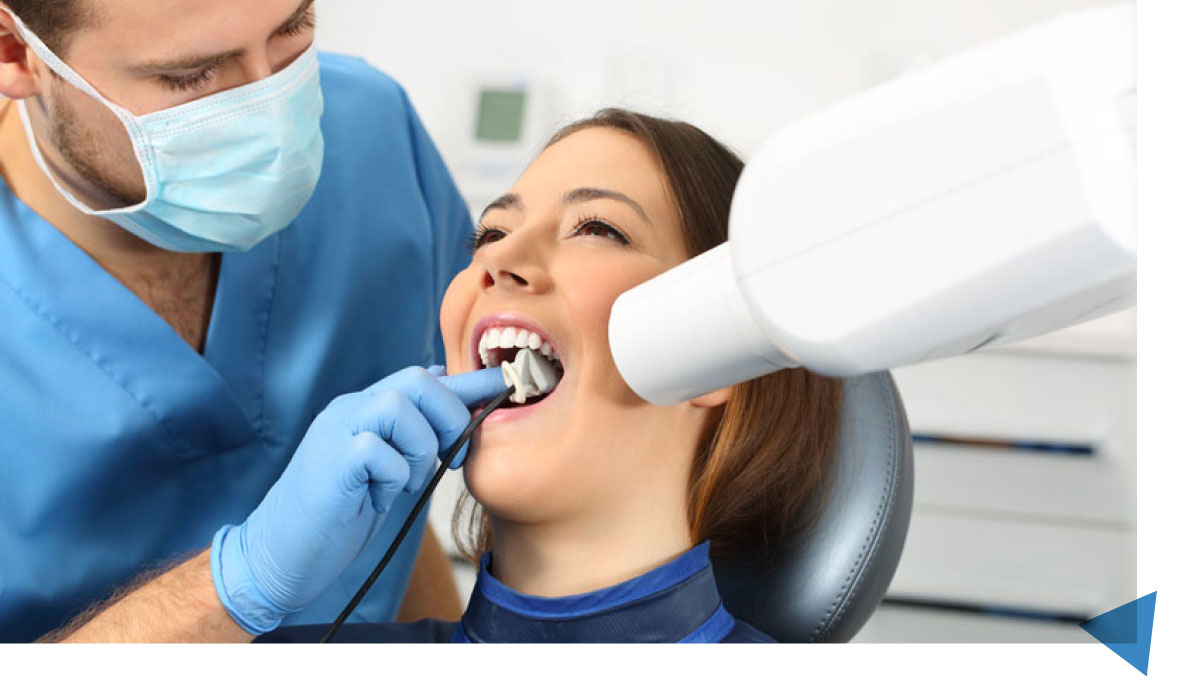 Dentist Examining A Woman's Teeth